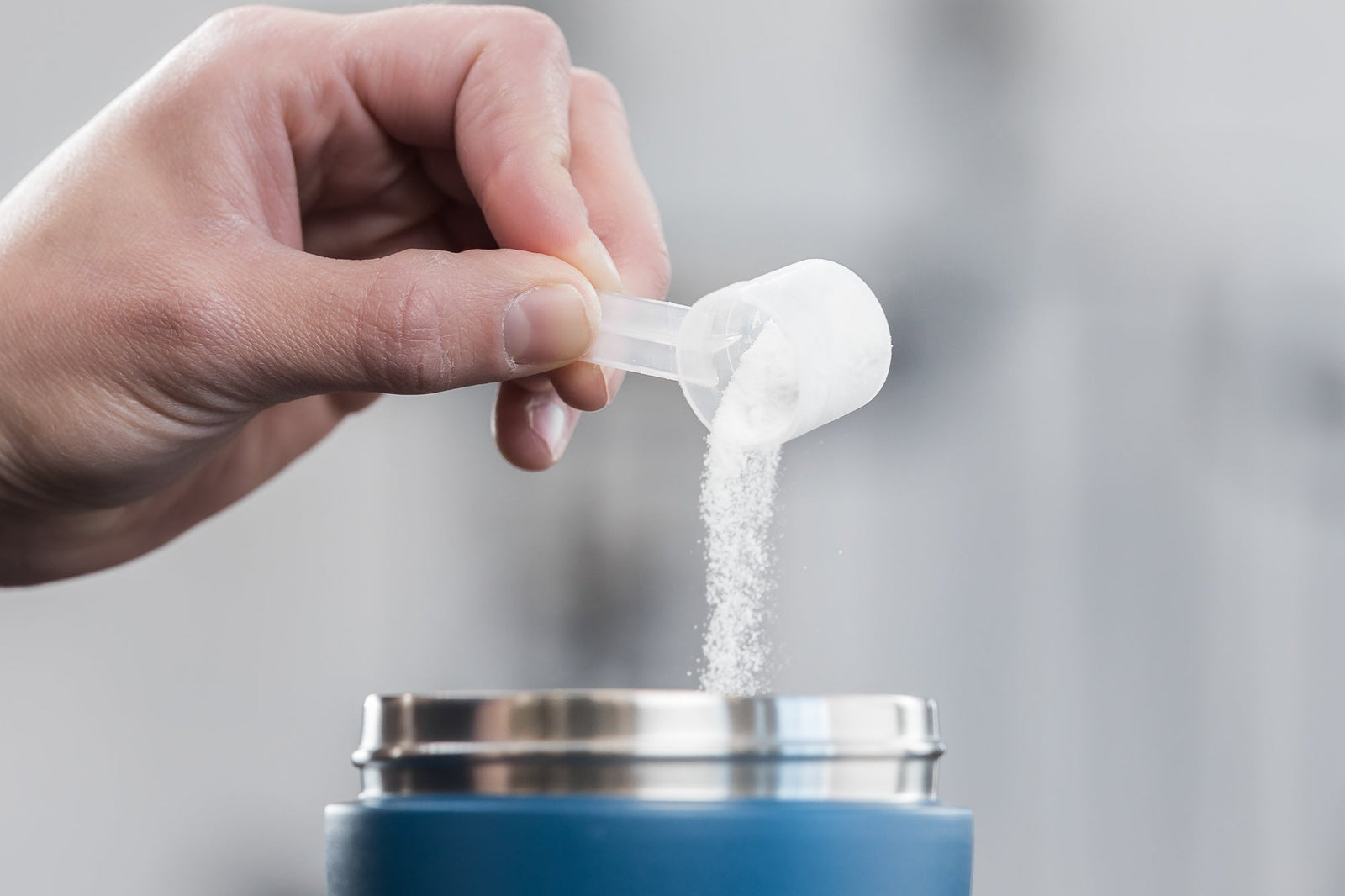 Hydration powder being poured into a shaker bottle